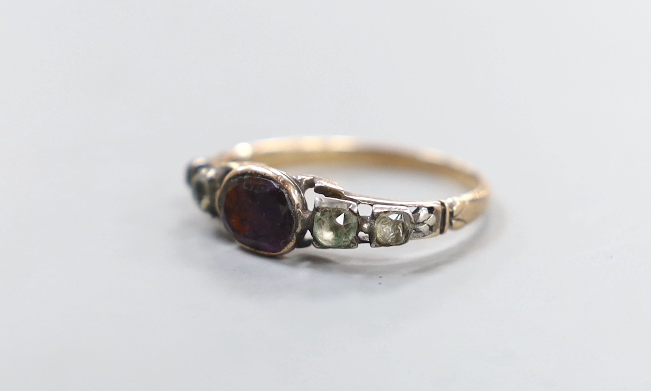 A Georgian yellow metal, garnet and paste set half hoop ring, size P, gross weight 2 grams.